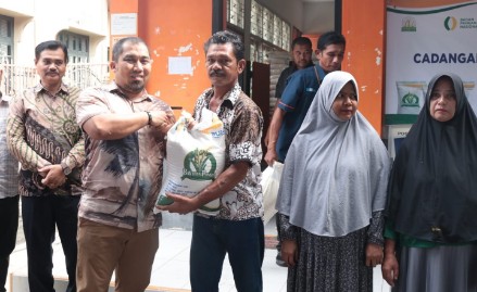 Pj Bupati Aceh Besar Muhammad Iswanto SSTP MM mendampingi salah satu warga yang sedang mengambil bantuan beras Cadangan Pangan Pemerintah tahap II, di Kantor PT Pos Capem Kecamatan Ingin Jaya, Aceh Besar, Sabtu (11/05/2024) pagi. FOTO/MC ACEH BESAR